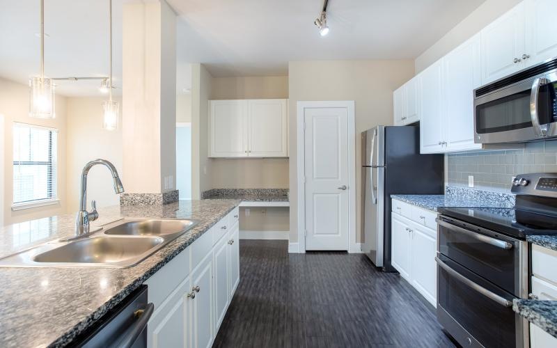 a kitchen with white cabinets